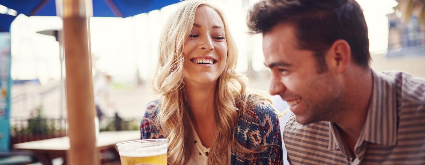 a man and woman holding drinks