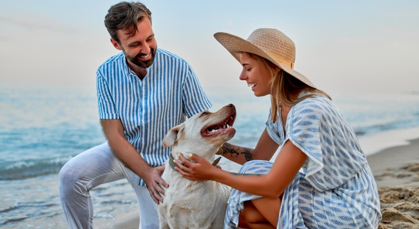 We love our furry friends a man and woman holding a dog